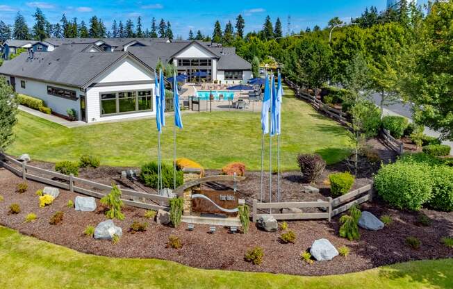 a backyard with blue flags and a house and a yard with a garden