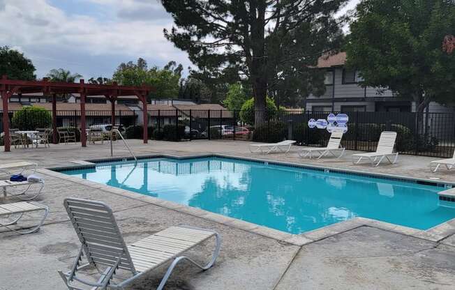 Swimming pool and sun deck at Dove Ridge Apartments in Riverside, CA.