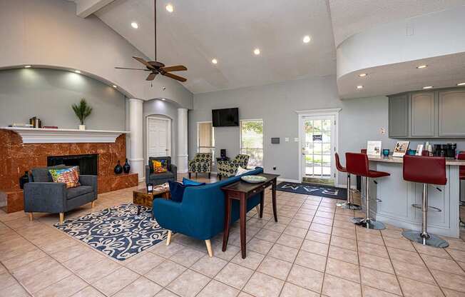 A living room with a fireplace and a blue chair.