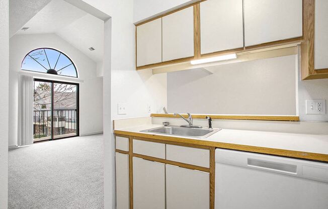 a kitchen with a dishwasher and a view at Hampton Lakes Apartments, Michigan, 49534