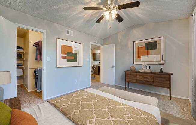 A bedroom with a bed, dresser, and mirror.