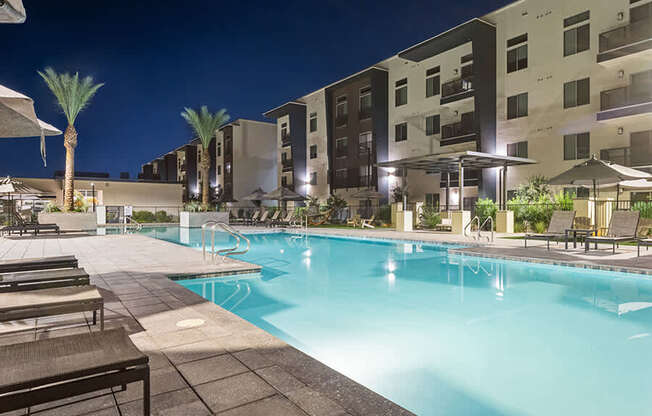 Community Swimming Pool with Pool Furniture at Glen 91 Apartments located in Glendale, AZ.