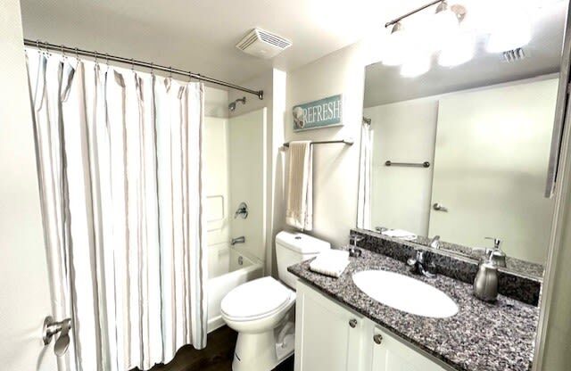 a bathroom with a shower toilet and a sink