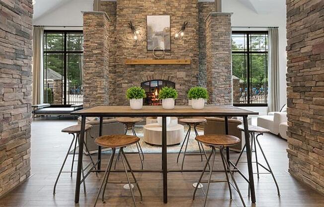 a dining room with a table and chairs and a fireplace in the background at Trails at Short Pump Apartments, Richmond ,23233