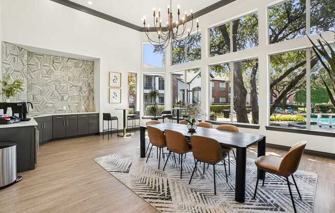 A modern dining room with a large table and chairs.