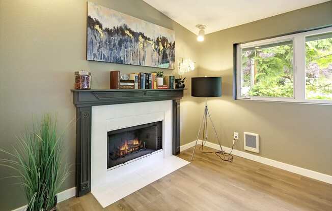 a living room with a fireplace and a window