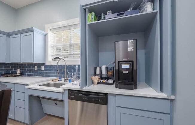 A kitchen with a dishwasher and a coffee machine.at Spring Creek Apartments, Crestview Florida