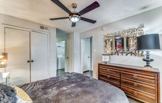 a bedroom with a bed and a ceiling fan