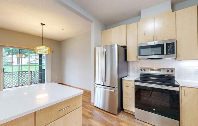 A kitchen with wooden cabinets and stainless steel appliances.