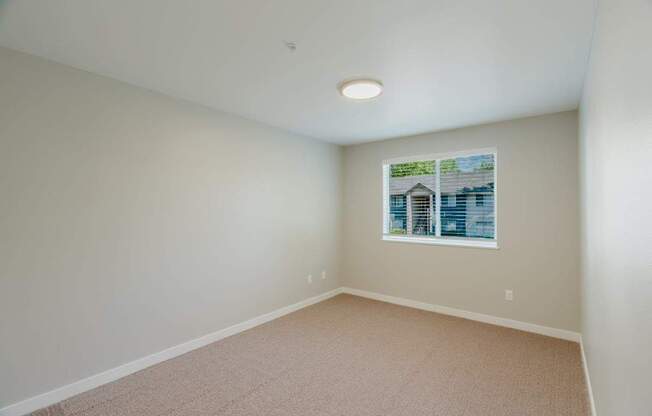 Empty room with carpeted floor and a picture on the wall.