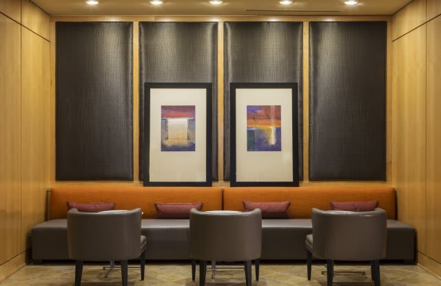 a lobby with chairs and pictures on the wall