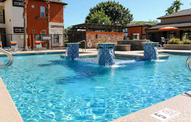 A pool with a blue water feature in the middle.