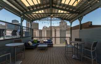 a roof deck with a view of the city