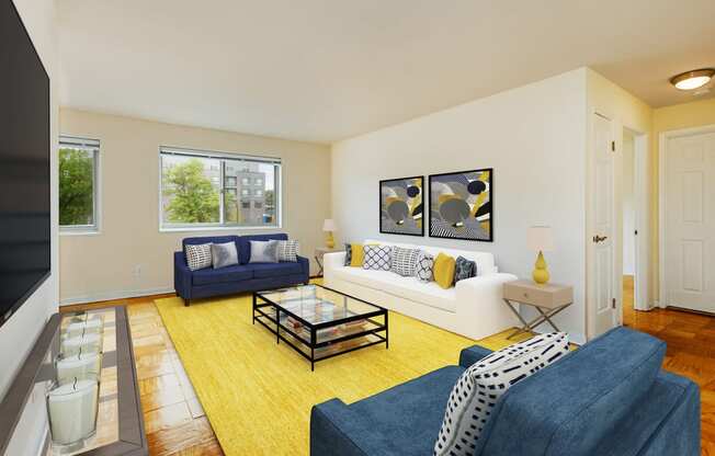 living area with large windows, sofa, love seat and coffee table at chillum place apartments in washington dc