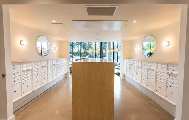 a dressing room with white lockers and a table in the middle