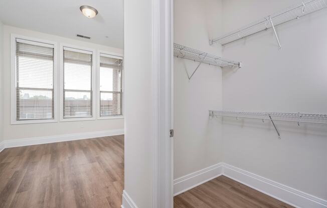 a bedroom with hardwood floors and white walls