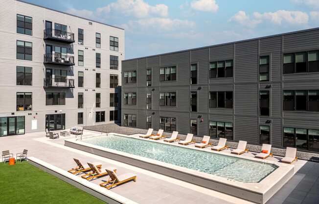 a swimming pool in the middle of two apartment buildings