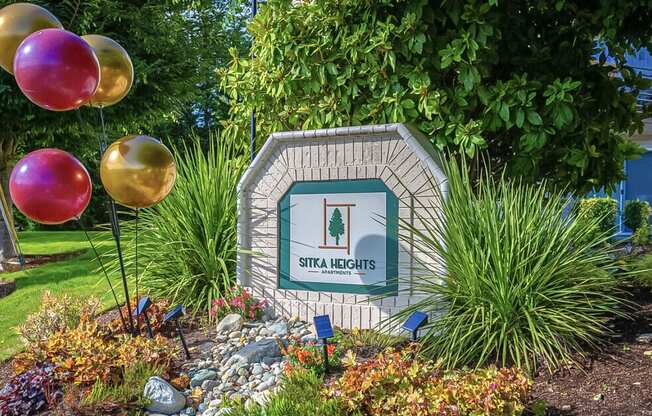 a sign in a garden with balloons  at Sitka Heights, Fife, WA