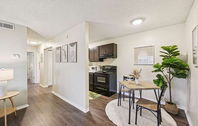 A kitchen with a table and chairs in the middle of the room.