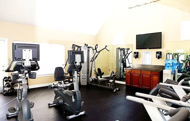 A gym with a variety of exercise equipment including treadmills, stationary bikes, and weight machines.at Summerland Heights, Virginia, 22191