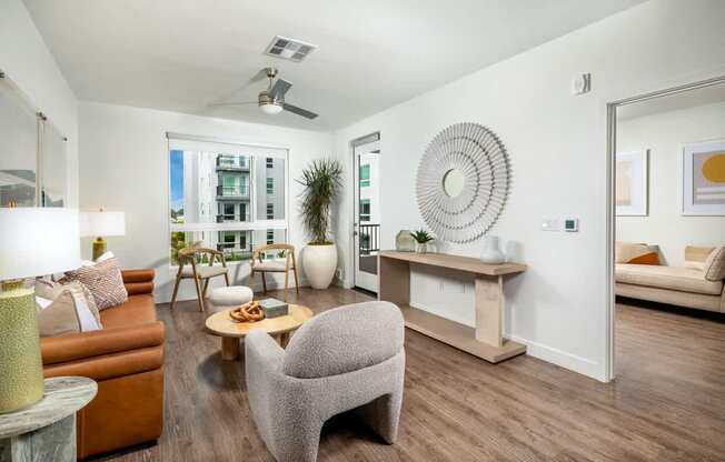 A living room with a brown couch, a grey armchair, and a coffee table.