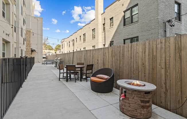 a patio with tables and chairs and a fire pit at Alton Jefferson Park, Denver, CO 80211
