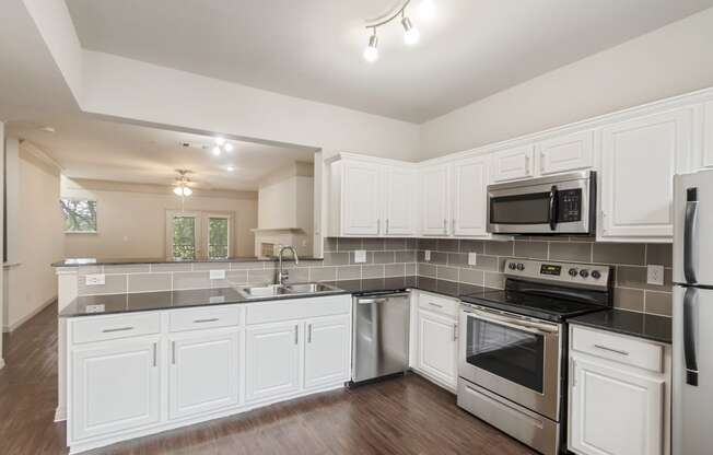 This is a picture of the kitchen of the 1320 square foot 2 bedroom, 2 and 1/2 bath floor plan at The Brownstones Townhome Apartments in Dallas, TX..