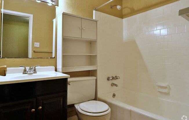 a bathroom with a sink toilet and tub