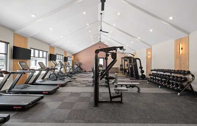 a gym filled with cardio equipment and weights