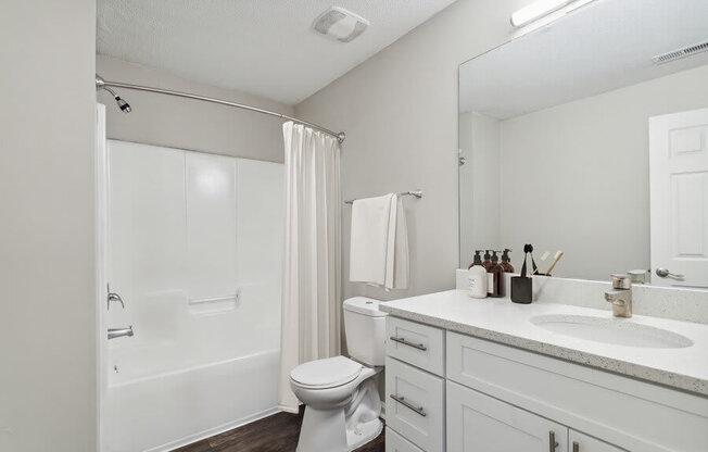 Model bathroom with tub and shower at Retreat at Stonecrest Apartments