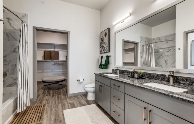 a bathroom with a shower and a sink and a mirror