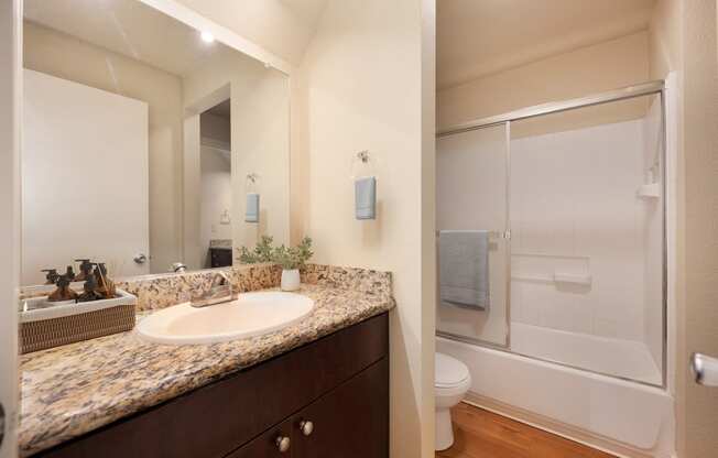 Bathroom with sink and shower with sliding shower doors