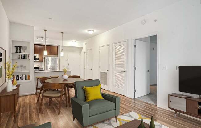 a living room and dining room with a table and chairs