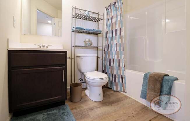 A bathroom with a toilet, sink, and a shower curtain.