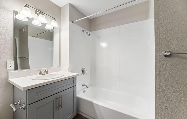 a room with a sink and a mirror