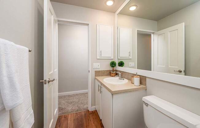 A white bathroom with a white tub and sink.