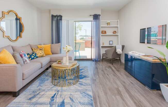 Apartment Living Room And Door To Patio At Union at Roosevelt Apartments In Phoenix, AZ