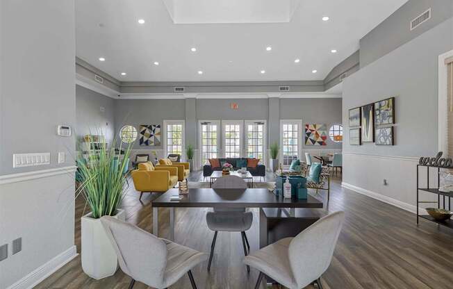 a living room with a large table and chairs
