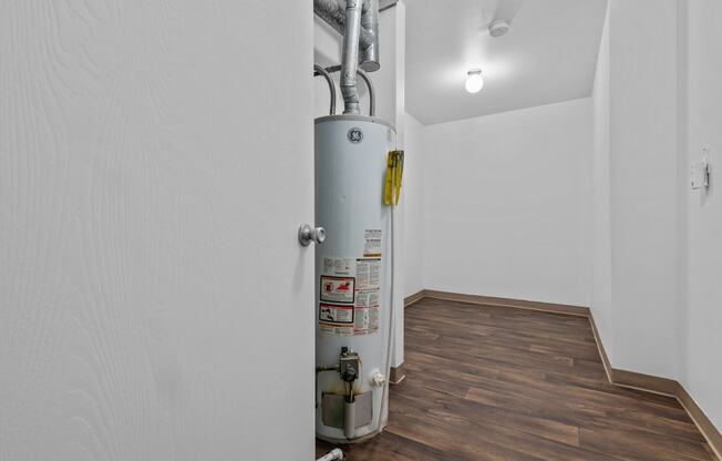 a white room with a gas heater in the corner at Edge At Farmington Hills - Farmington Hills, MI, Farmington Hills, MI