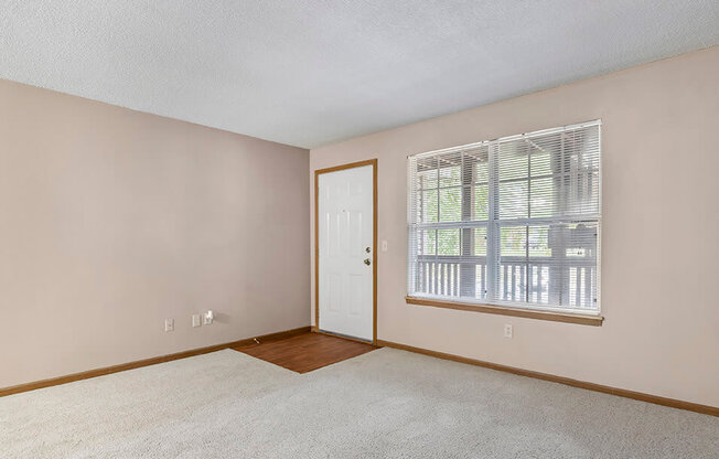 a bedroom with a large window and a door