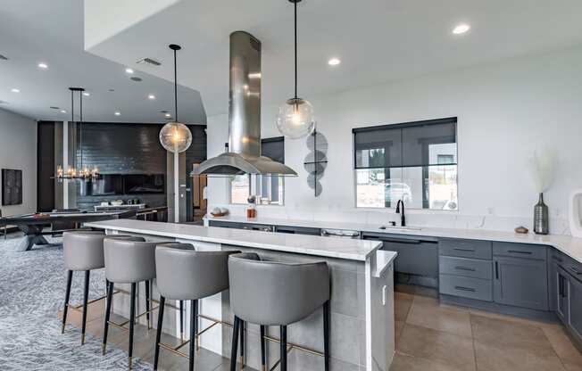 a large kitchen with an island and bar stools