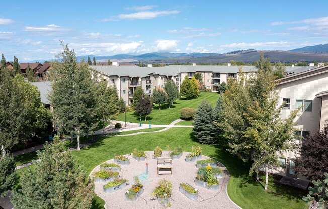 an aerial view of a courtyard with trees and a fountain