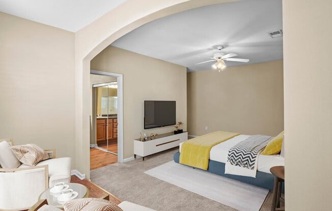 a bedroom with a bed and a tv
