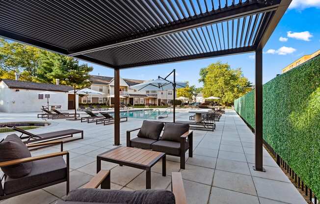 A patio with a table and chairs under a roof.