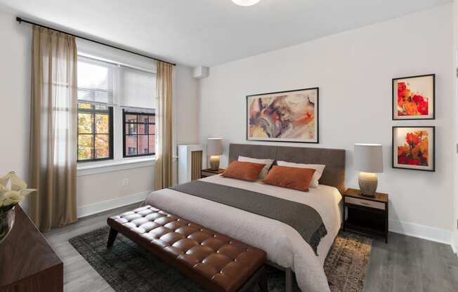 a bedroom with a bed and two windows