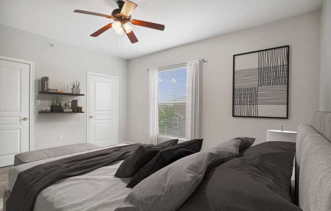 a bedroom with a large bed and a ceiling fan