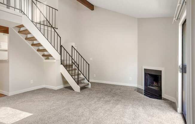 A living room with a fireplace and loft at Hilltop View Apartments