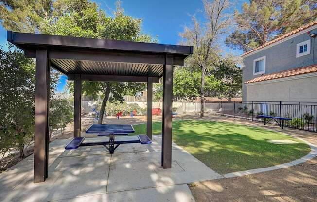 A park with a pavilion and a bench.
