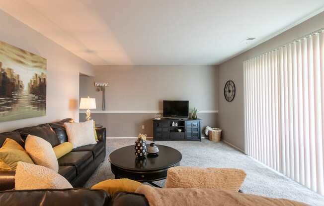 This is a picture of the living room in the 980 square foot, 2 bedroom, 1 bath model apartment at Fairfield Pointe Apartments in Fairfield, Ohio.