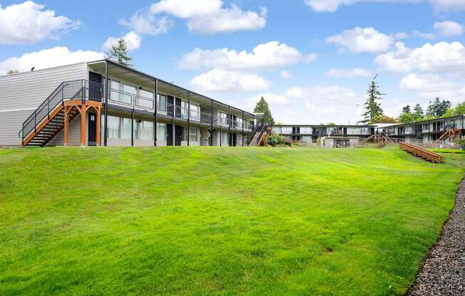 A modern building with a green lawn in front.